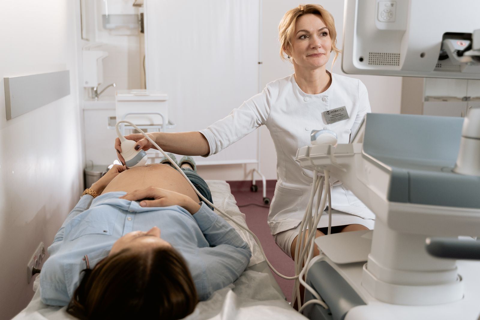 A sonographer performing an ultrasound exam on a patient